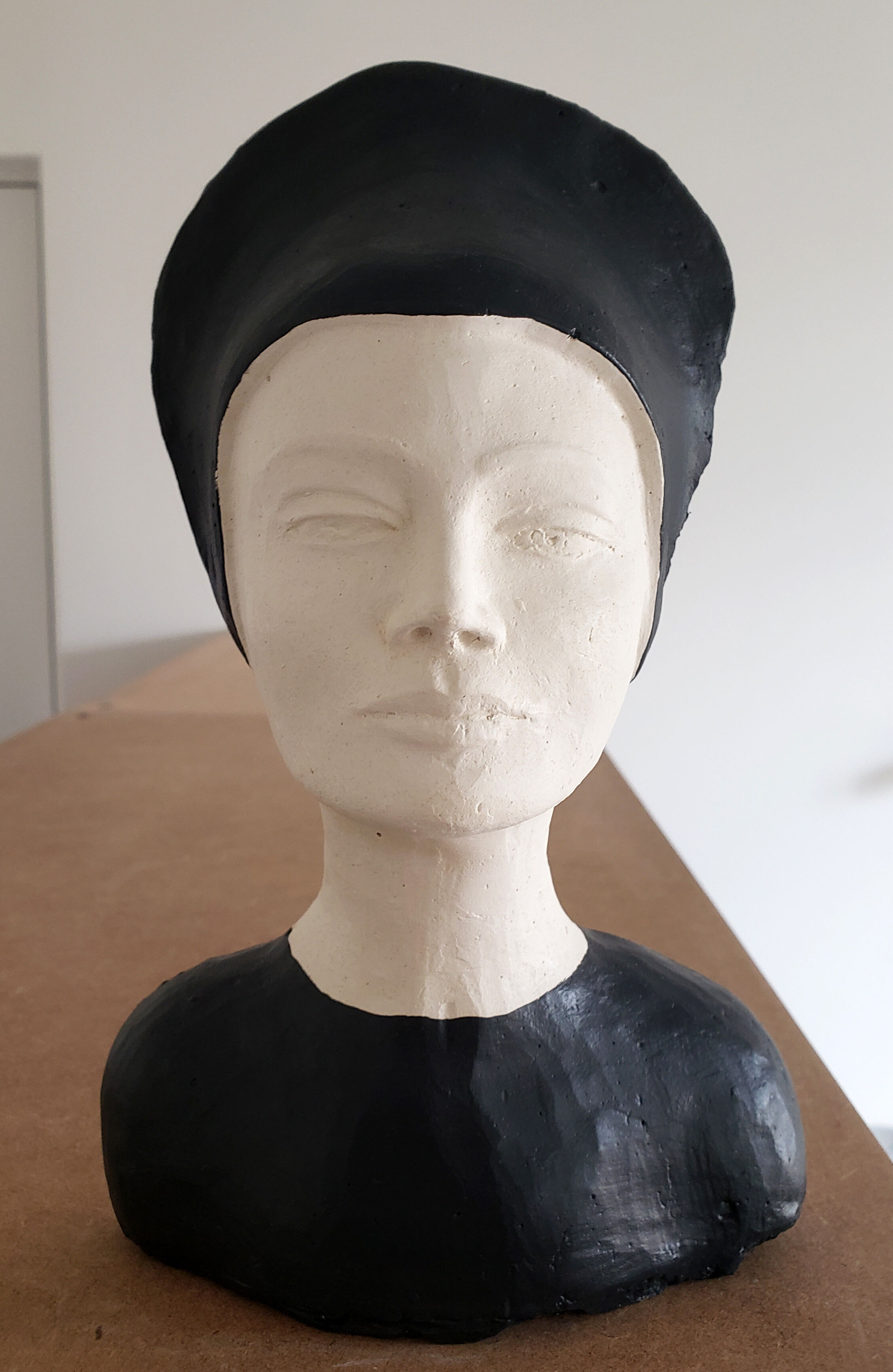 Bust of a woman in anthracite and white plaster