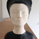 Bust of a woman in anthracite and white plaster