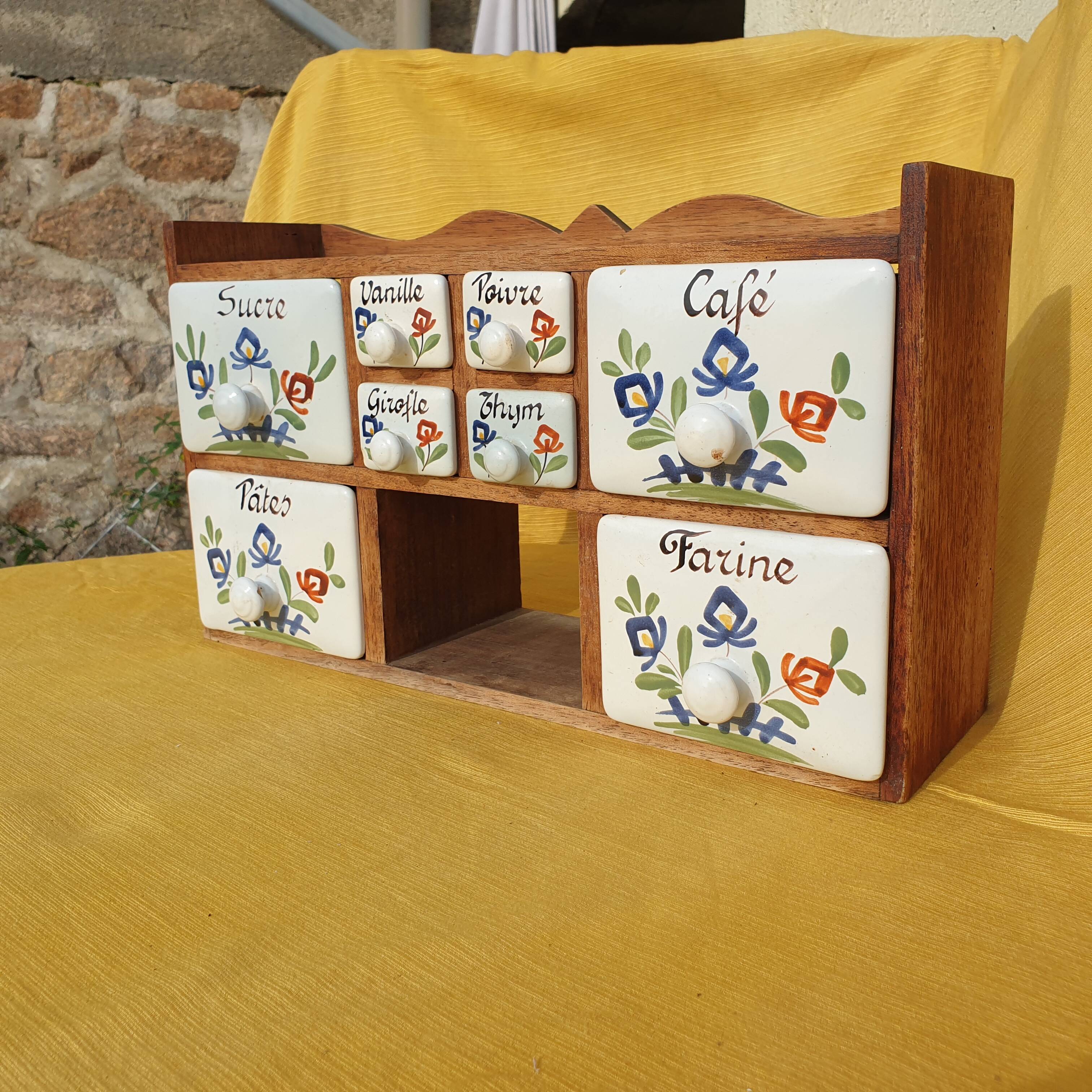 Vintage wooden spice rack with ceramic drawers