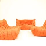 Togo sofa set and armchairs in pumpkin orange, 3 pieces, no label.