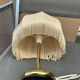 Vintage table lamp with fringed shade – gilded brass – 1970s