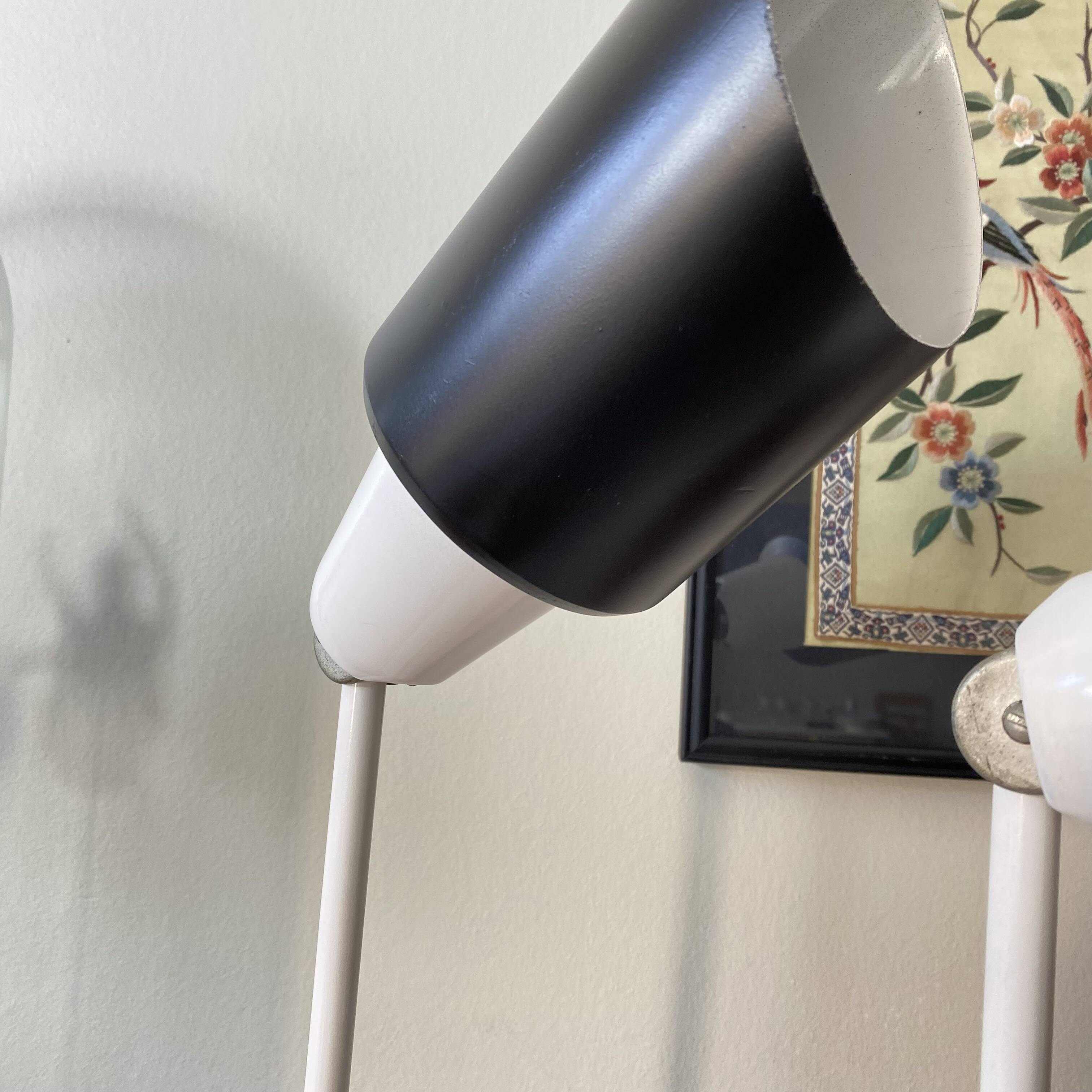 Pair of adjustable industrial metal wall sconces.