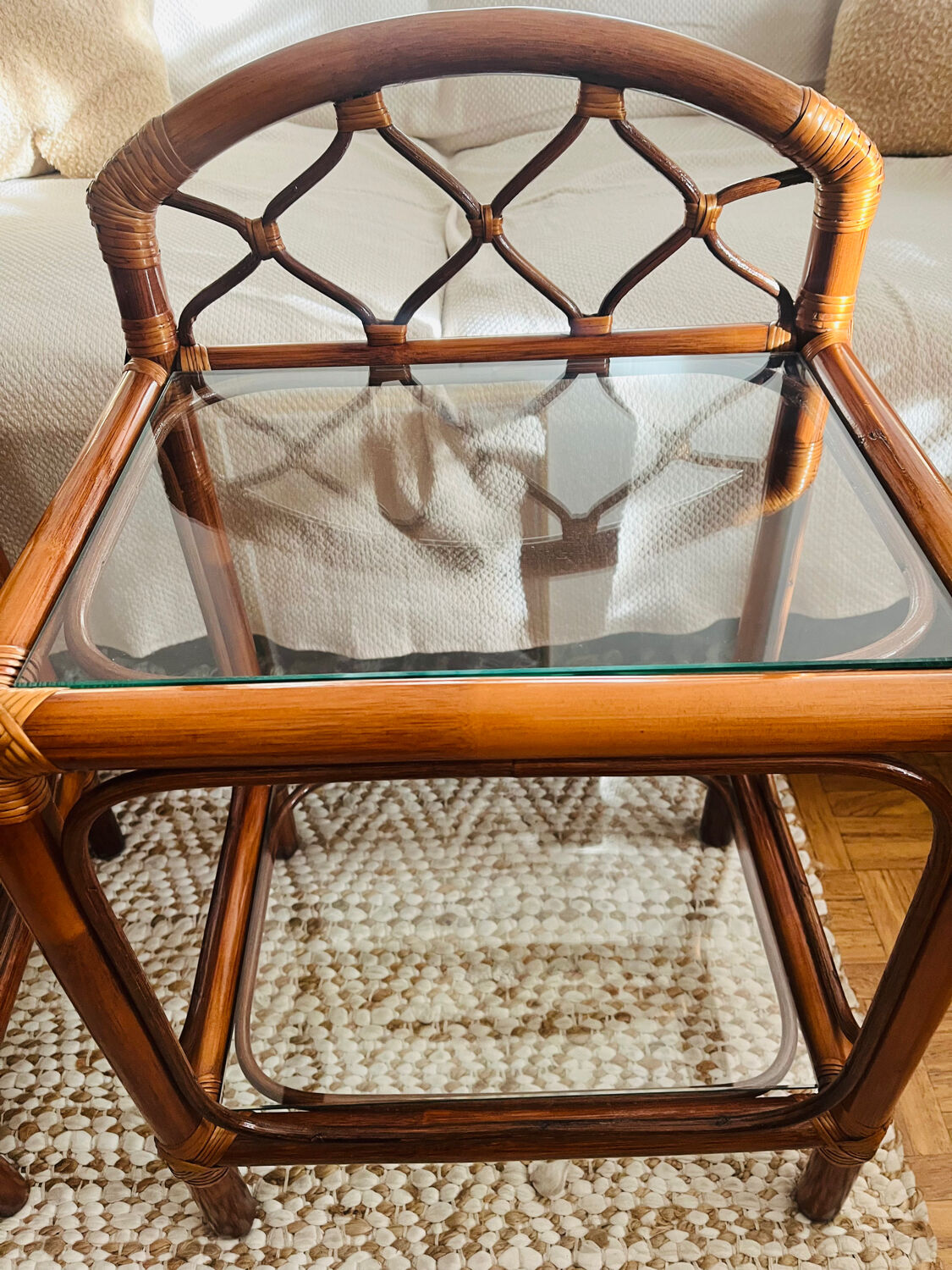 Two rattan and glass bedside tables