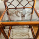 Two rattan and glass bedside tables
