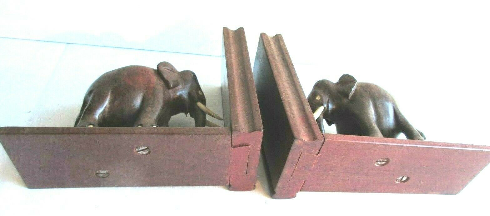 Art Deco bookends wooden elephants and bones on wooden terrace, book shape