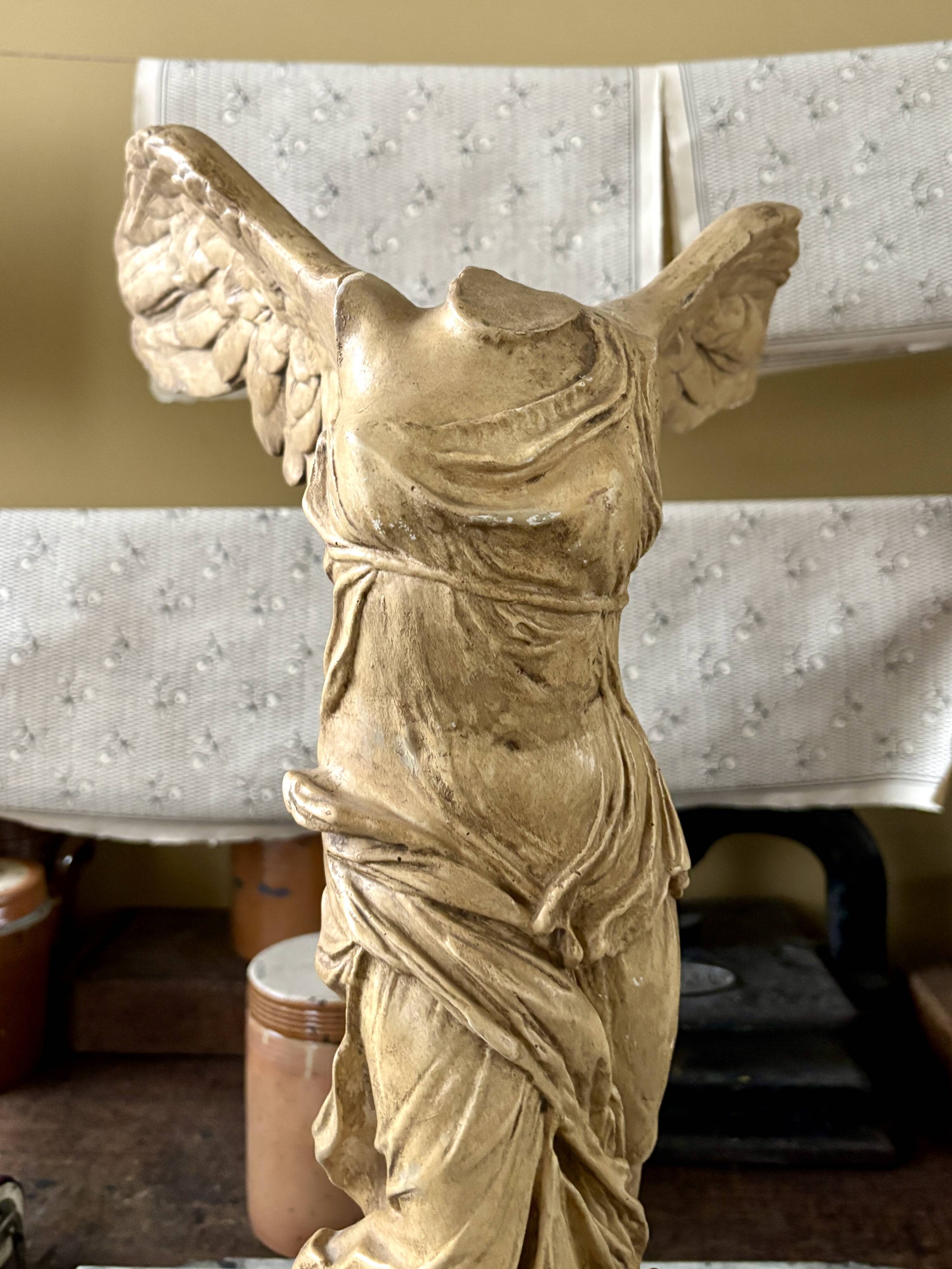 "Winged Victory of Samothrace", beige plaster statuette
