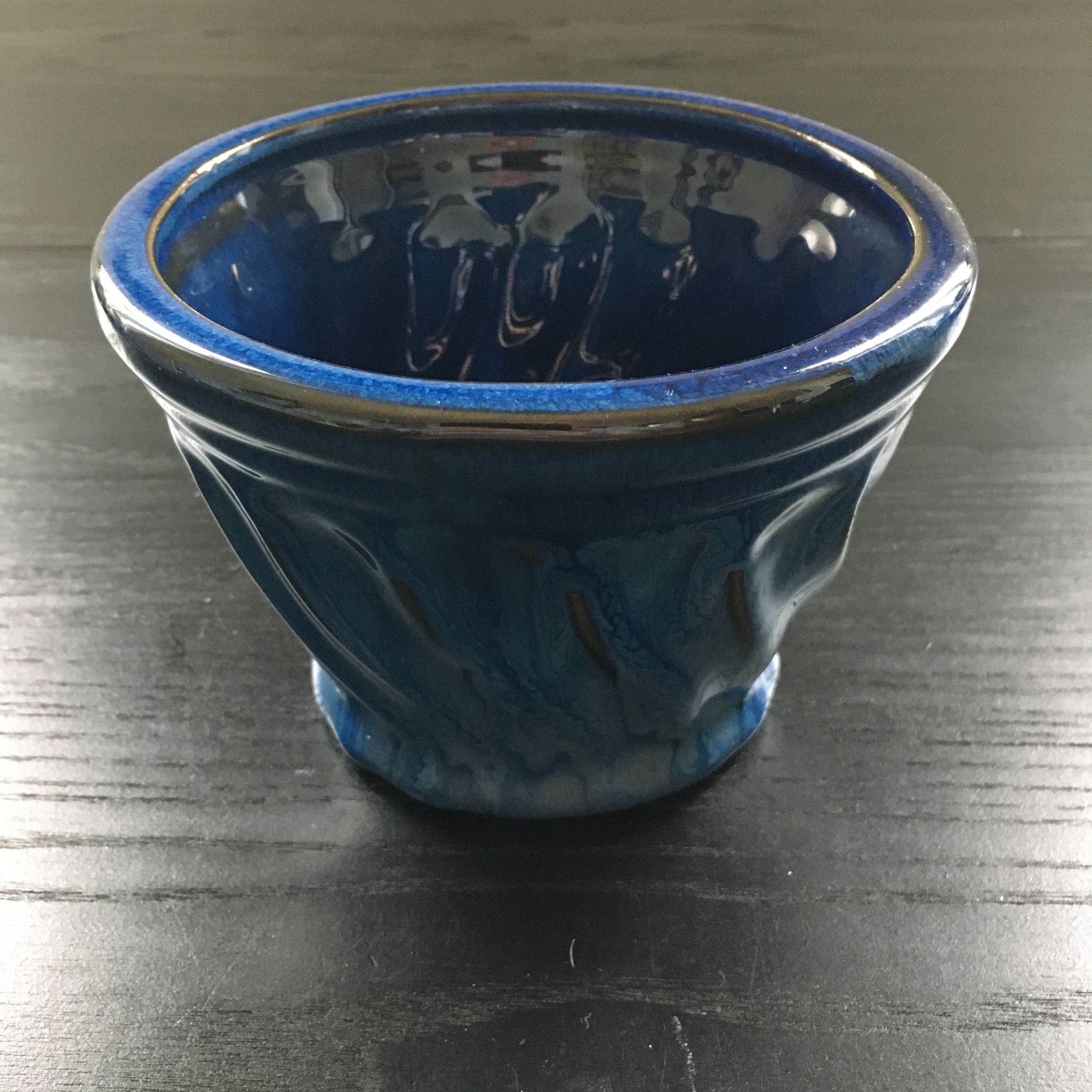 Navy blue stoneware pot.