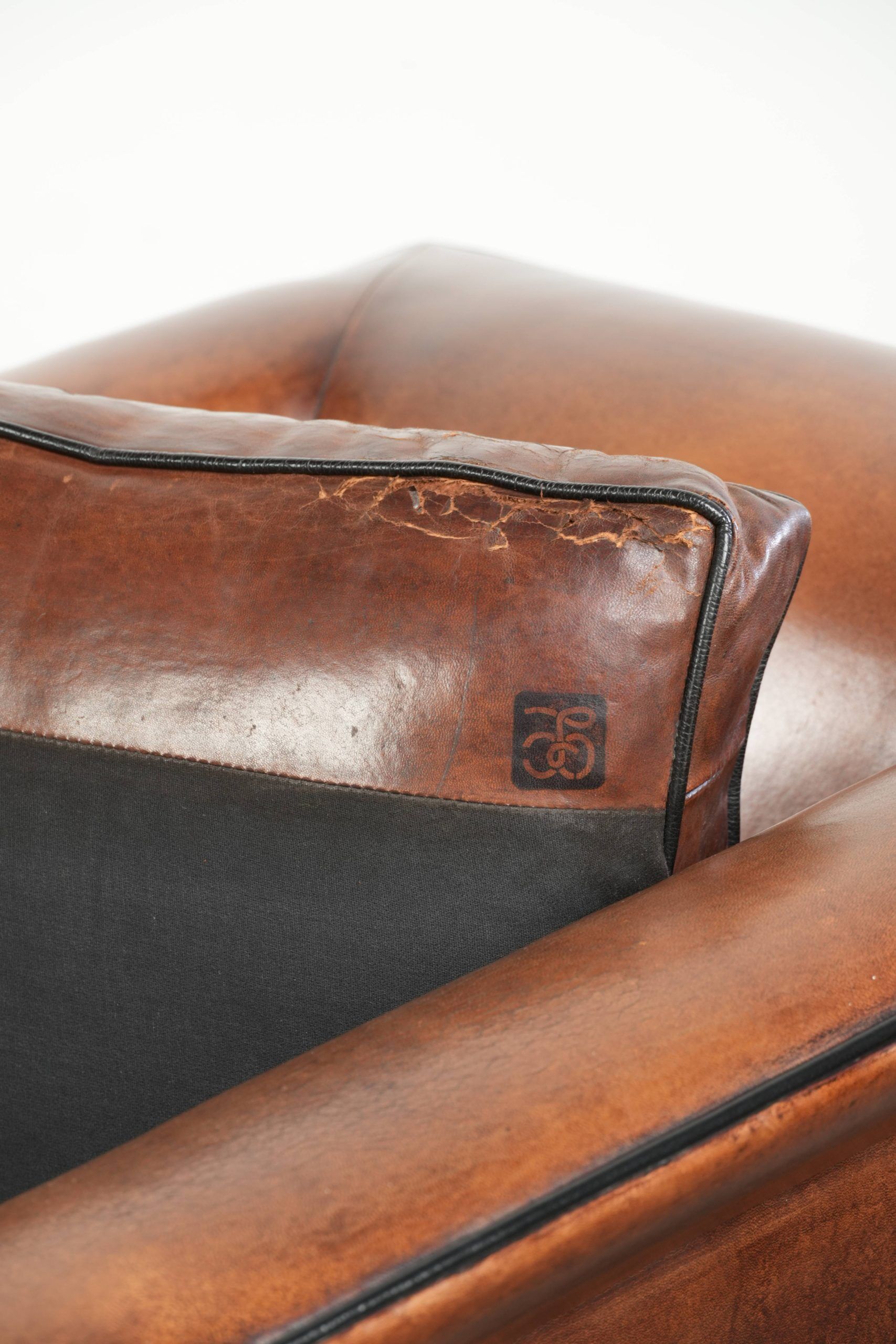 Sleek sheepskin Art Deco design armchair with black piping