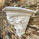 Antique wall console in patinated white plaster.