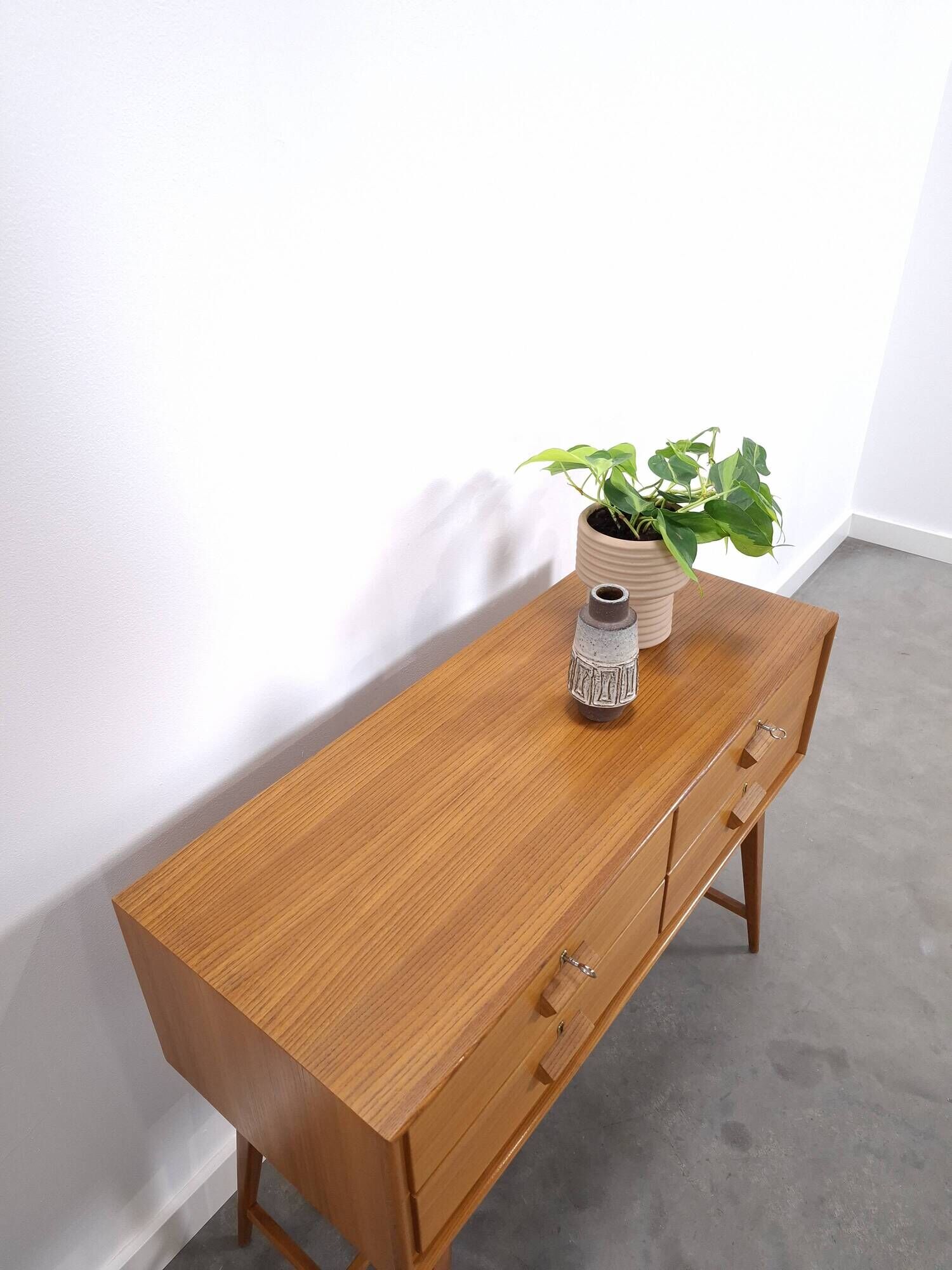 Vintage teak Danish chest of drawers with high slanted legs, side table, sideboard.