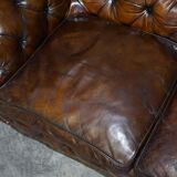 Victorian Chesterfield leather upholstered canapé with feather cushions.