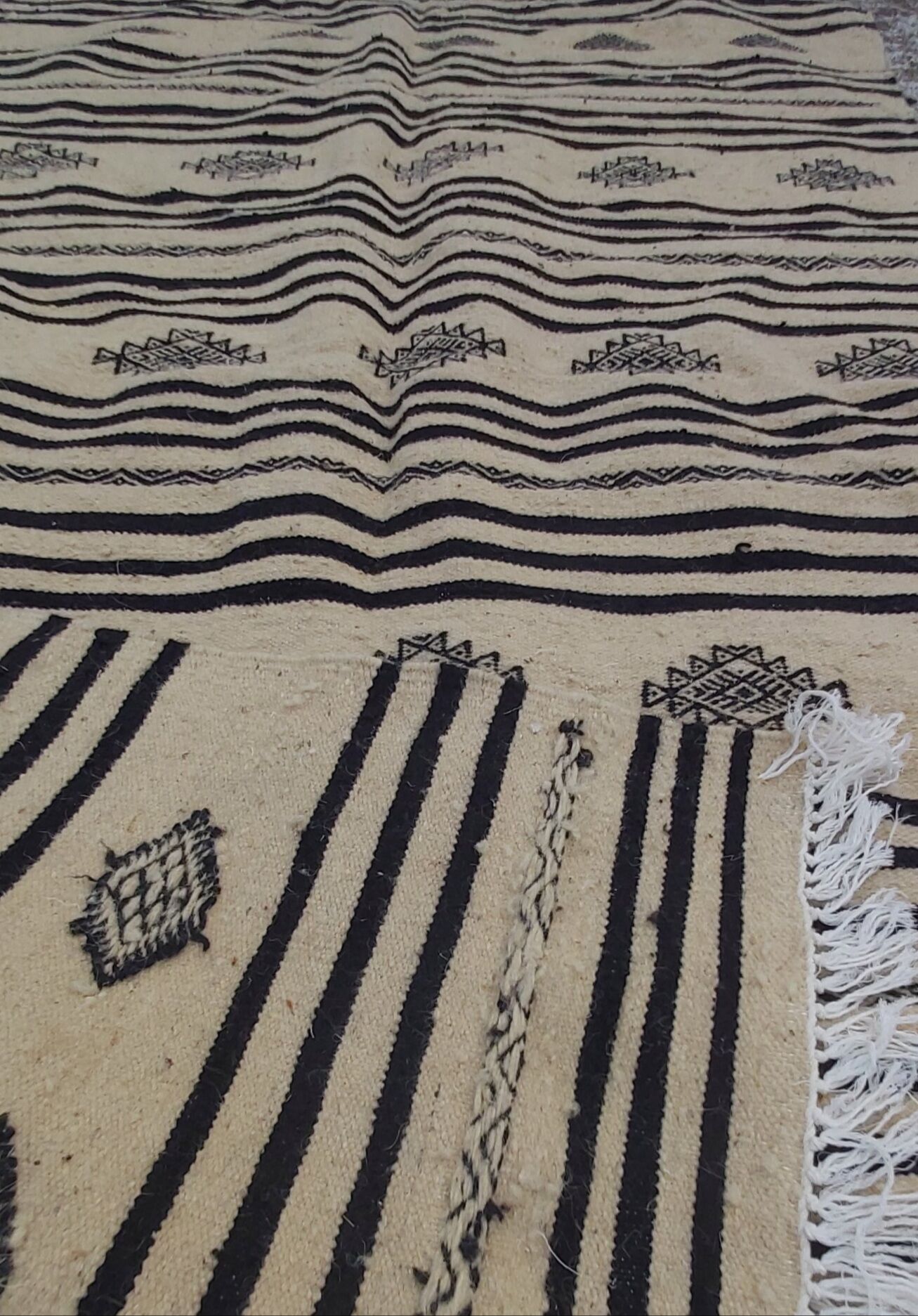Traditional hand-woven beige and black carpet