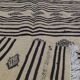 Traditional hand-woven beige and black carpet