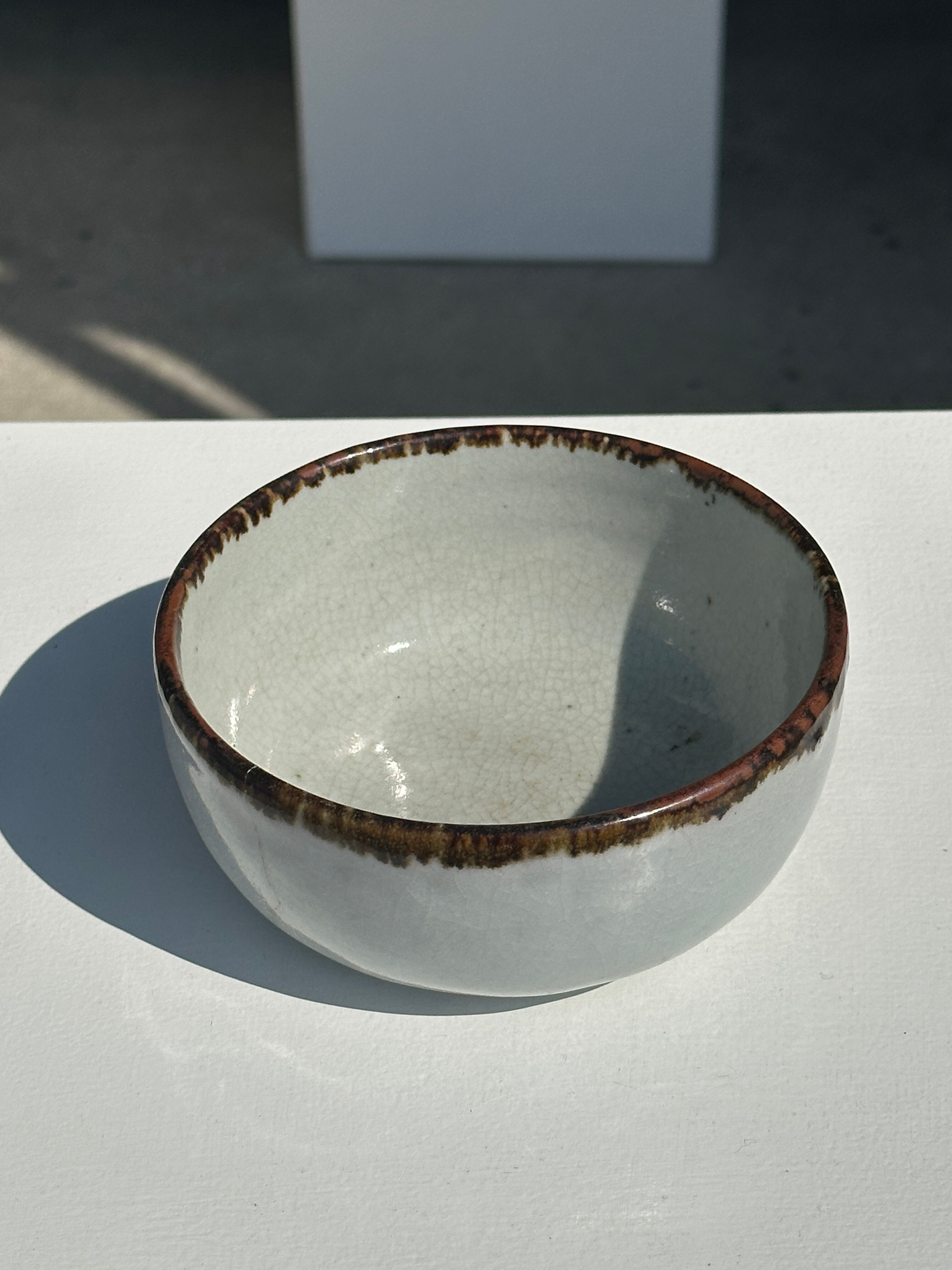 Small white glazed ceramic bowl black edges