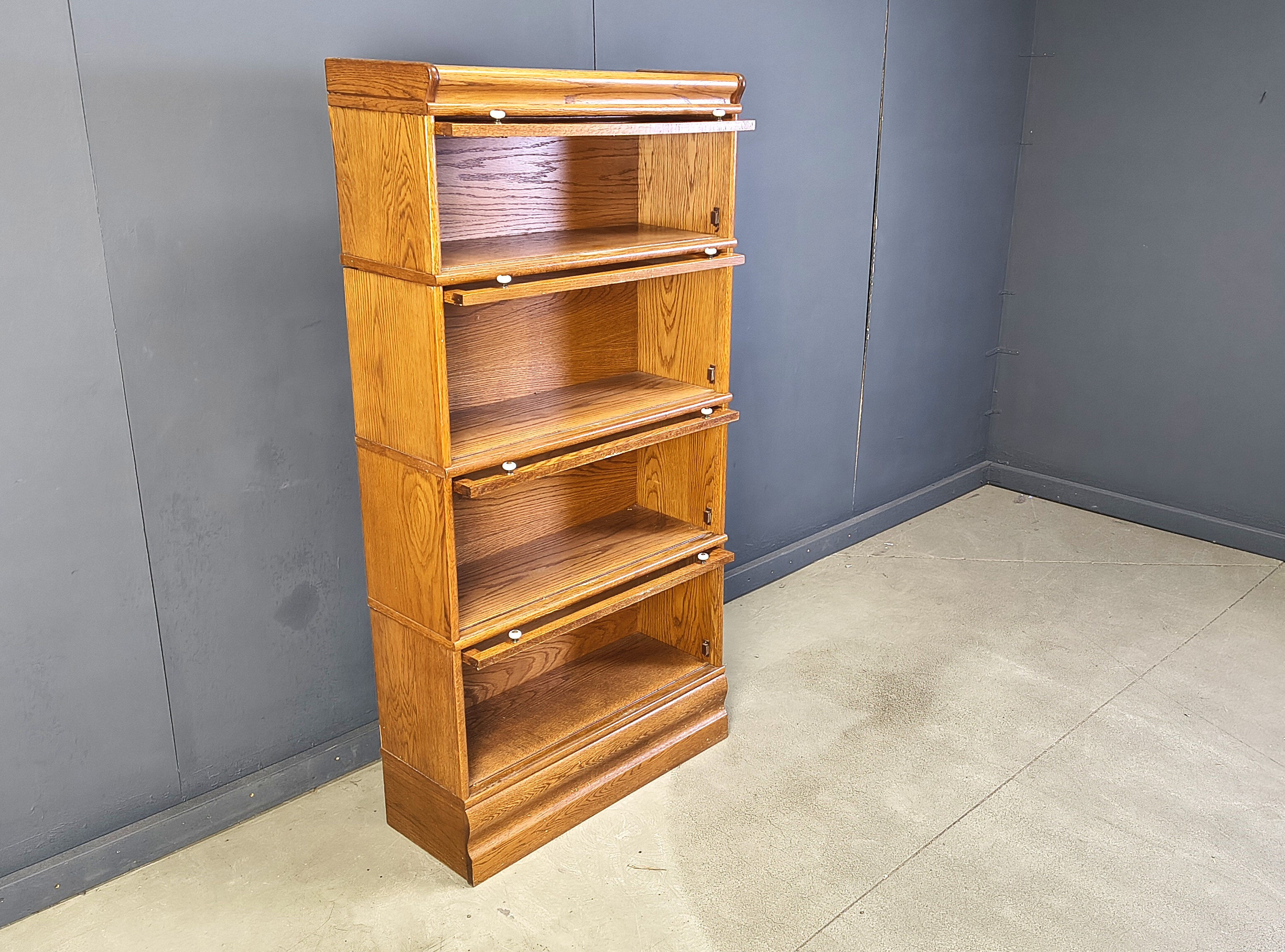 Four tier oak barrister style bookcase with leaded glass