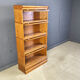 Four tier oak barrister style bookcase with leaded glass