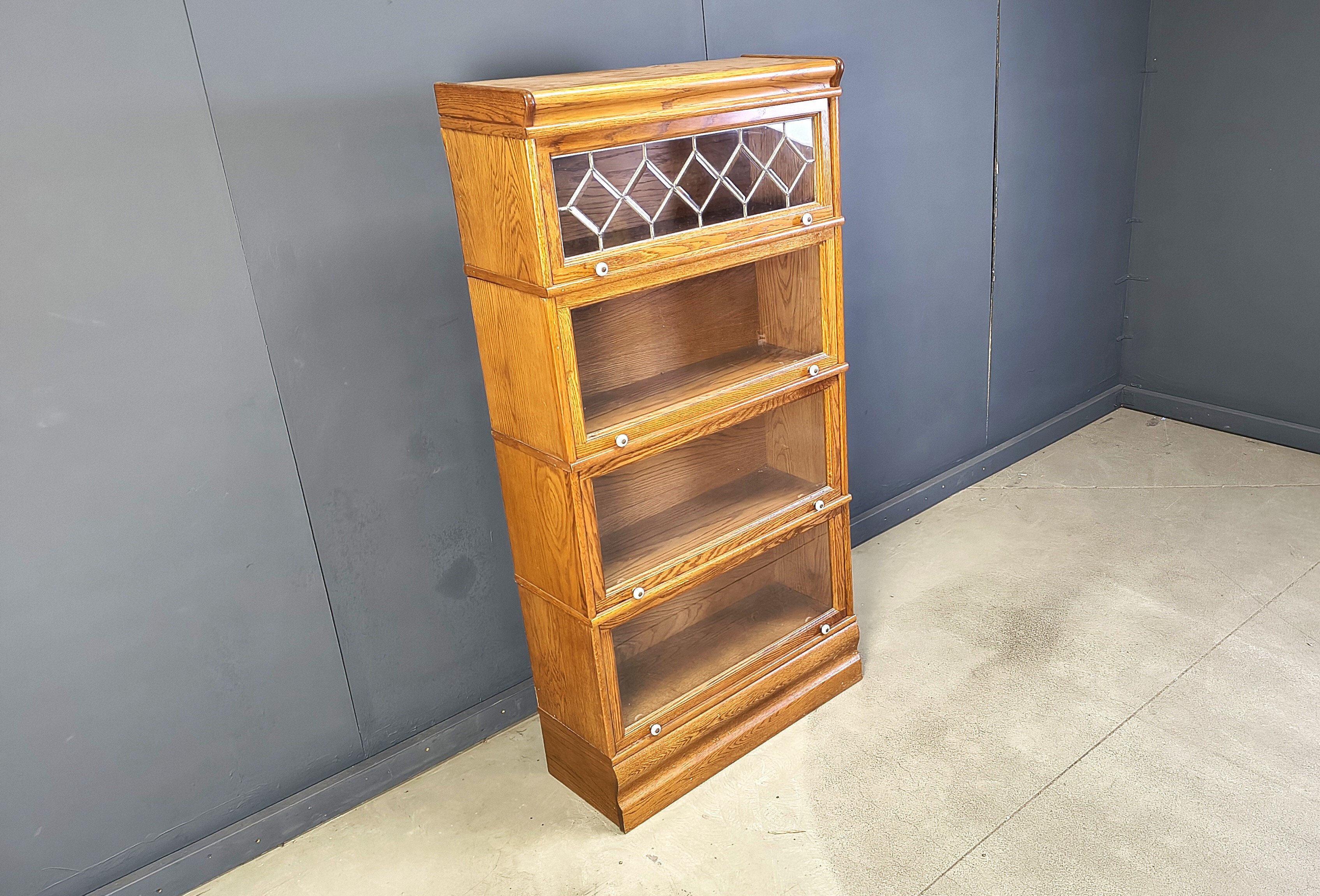 Four tier oak barrister style bookcase with leaded glass