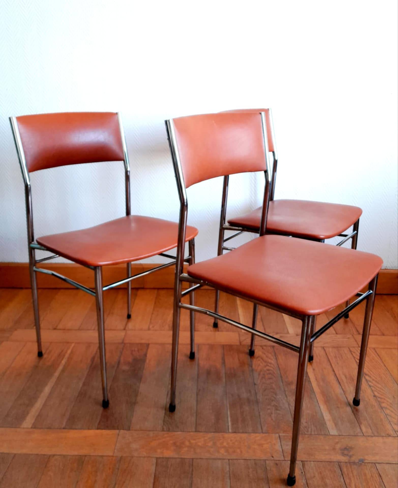 Three mid-century chairs in faux leather and chrome from the 1950s.