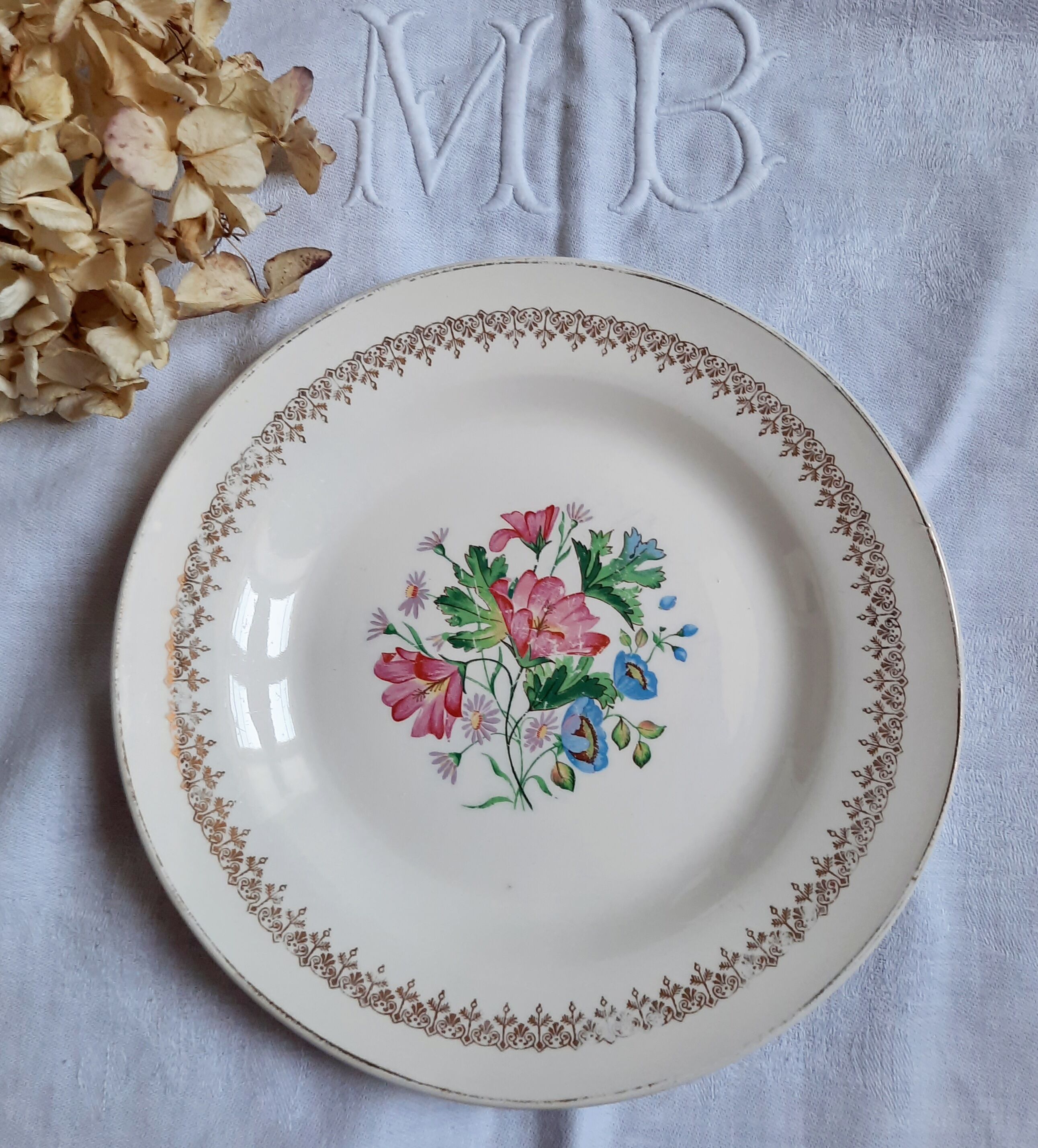 Flat antique earthenware plates with gilded edges