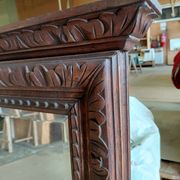 Large bevelled mirror with a carved wooden frame