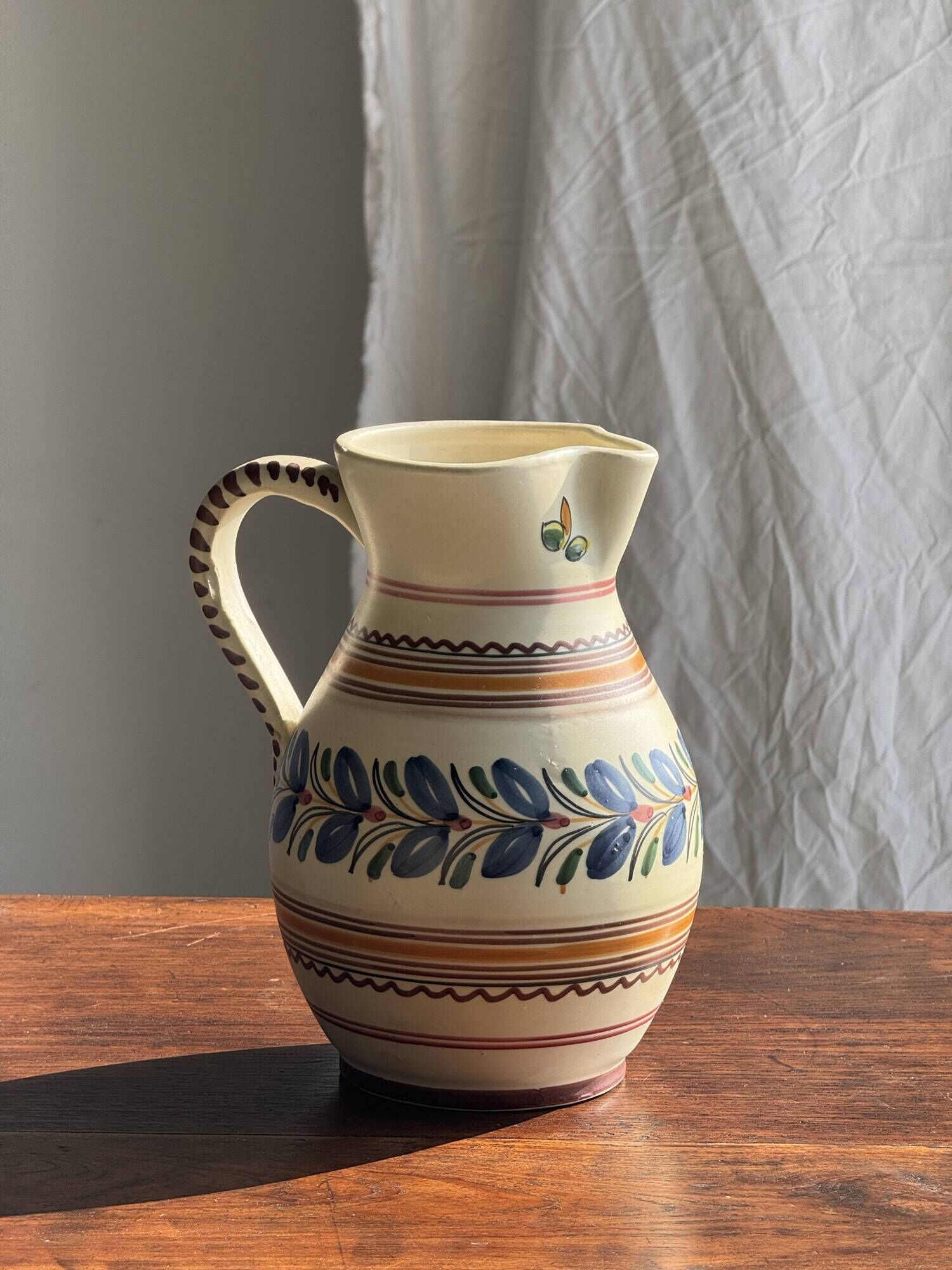 Beige carafe with stylized blue flower friezes