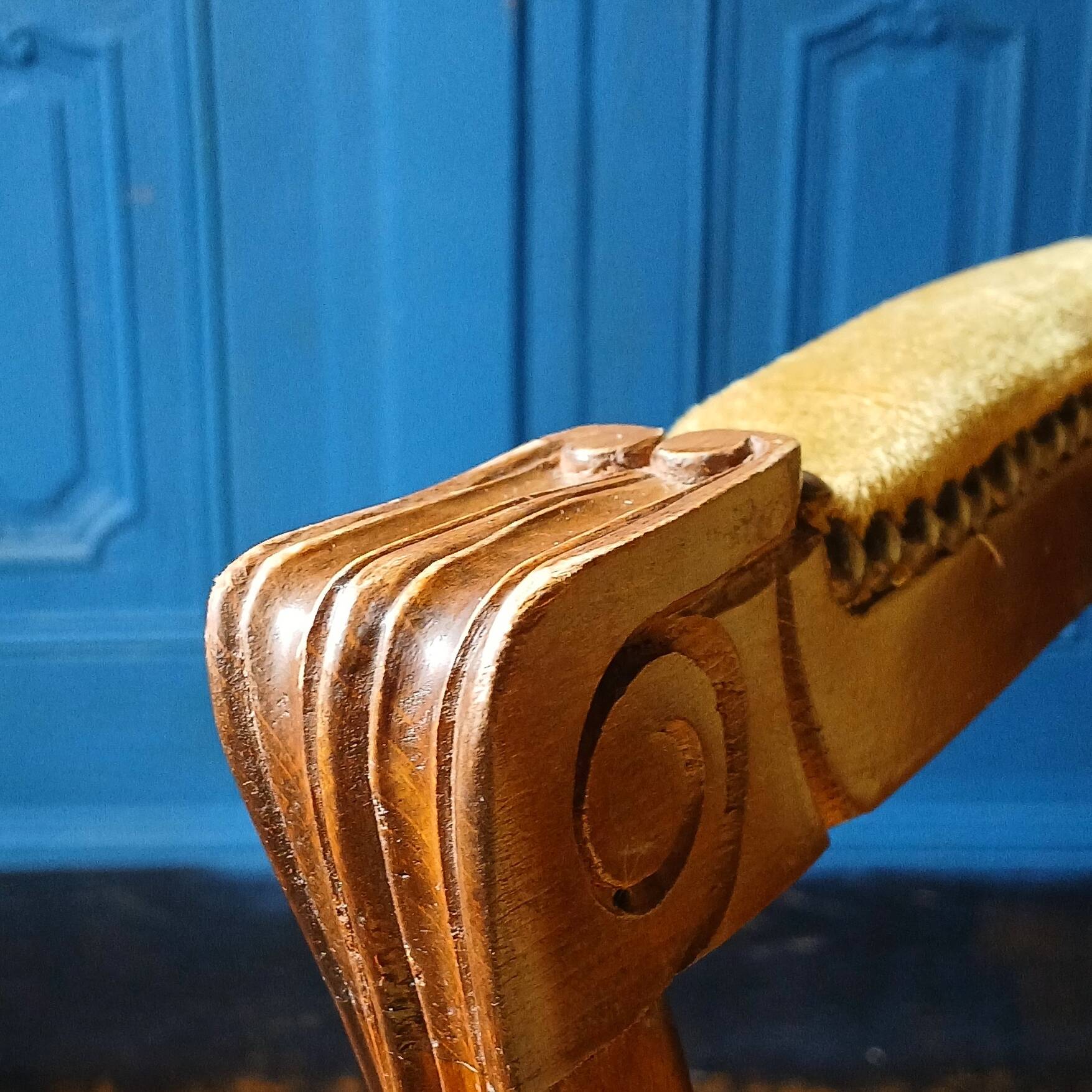 Velvet cabriolet armchair with decorative copper studs.