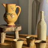 Large antique handmade ochre yellow jug with a pink flower pattern.