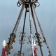Wrought chandelier in Gothic style.