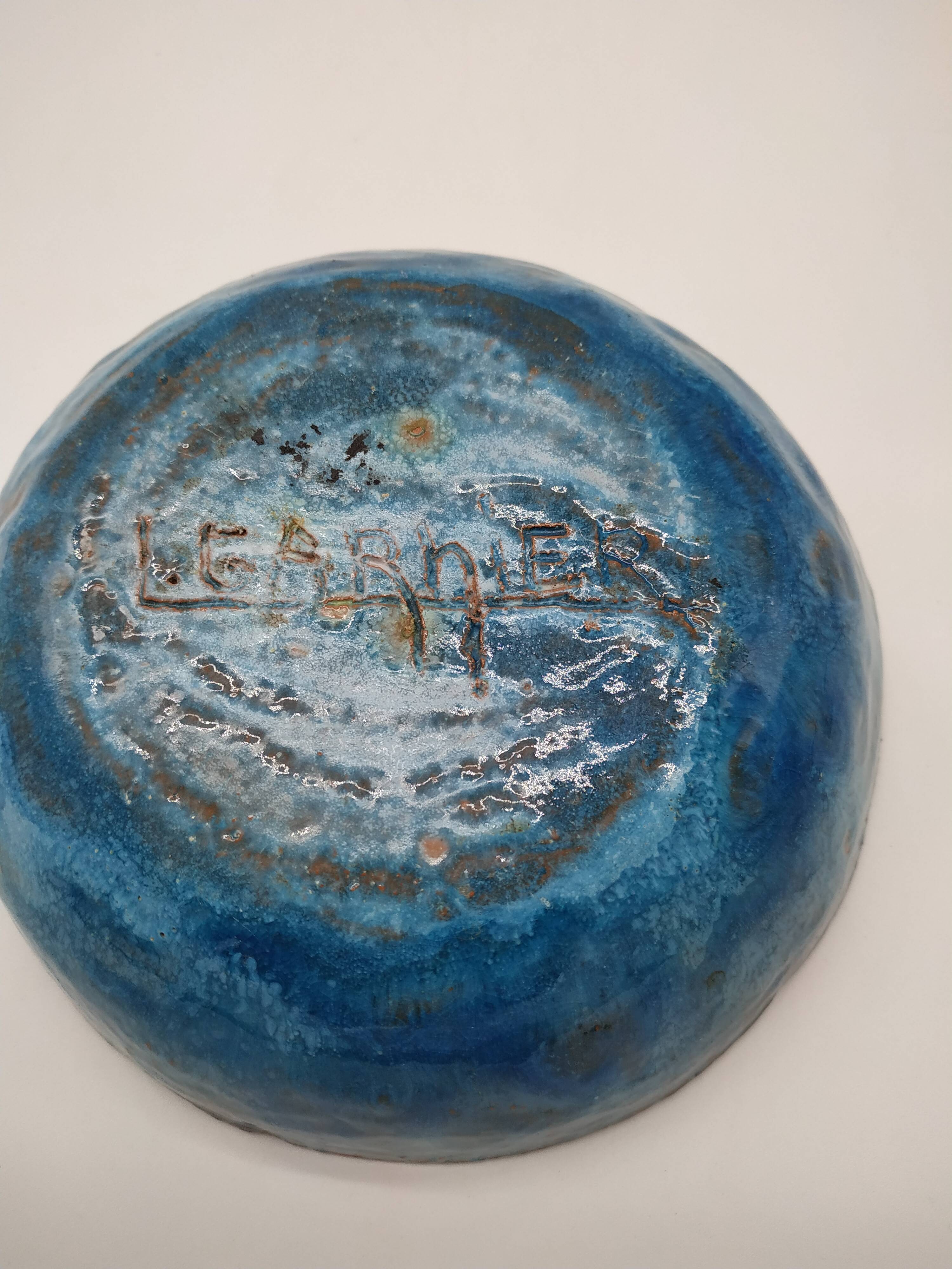 Hollow cut in blue enamelled sandstone decorated with yellow flowers