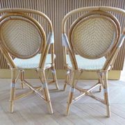 Pair of Parisian bistro chairs from Maison Louis Drucker in light Manila rattan.