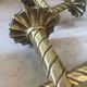 Pair of neoclassical wall sconces in twisted brass and ribbed glass.