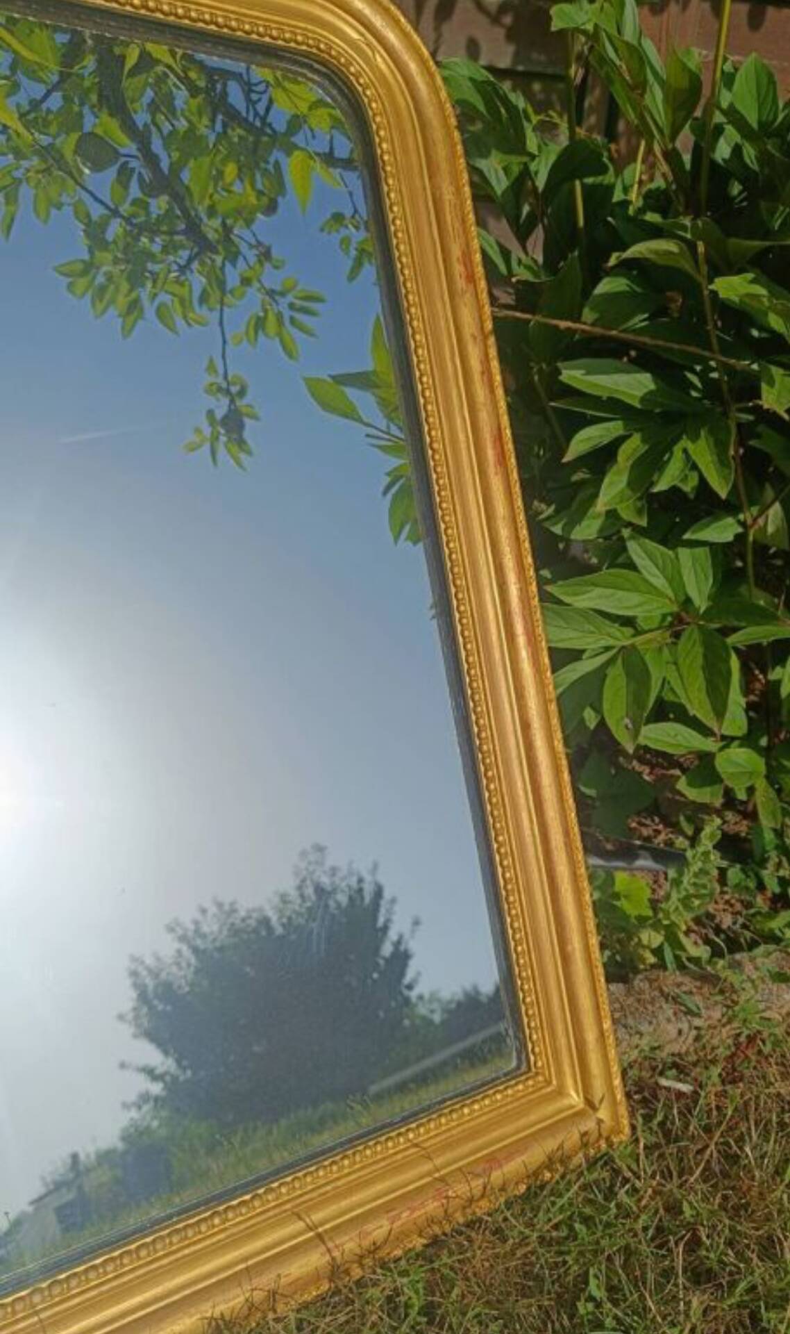 Antique Louis-Philippe mirror, gilded and patinated.