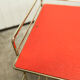 Red and brass vintage roulette service with vinyl record rack