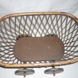 Cradle of doll in rattan on wheels