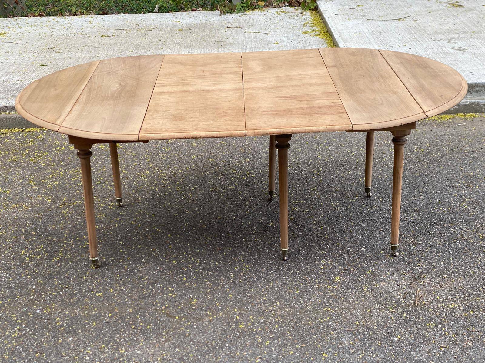 Renovated Louis Philippe round extendable dining table with leaves from the 18th century.