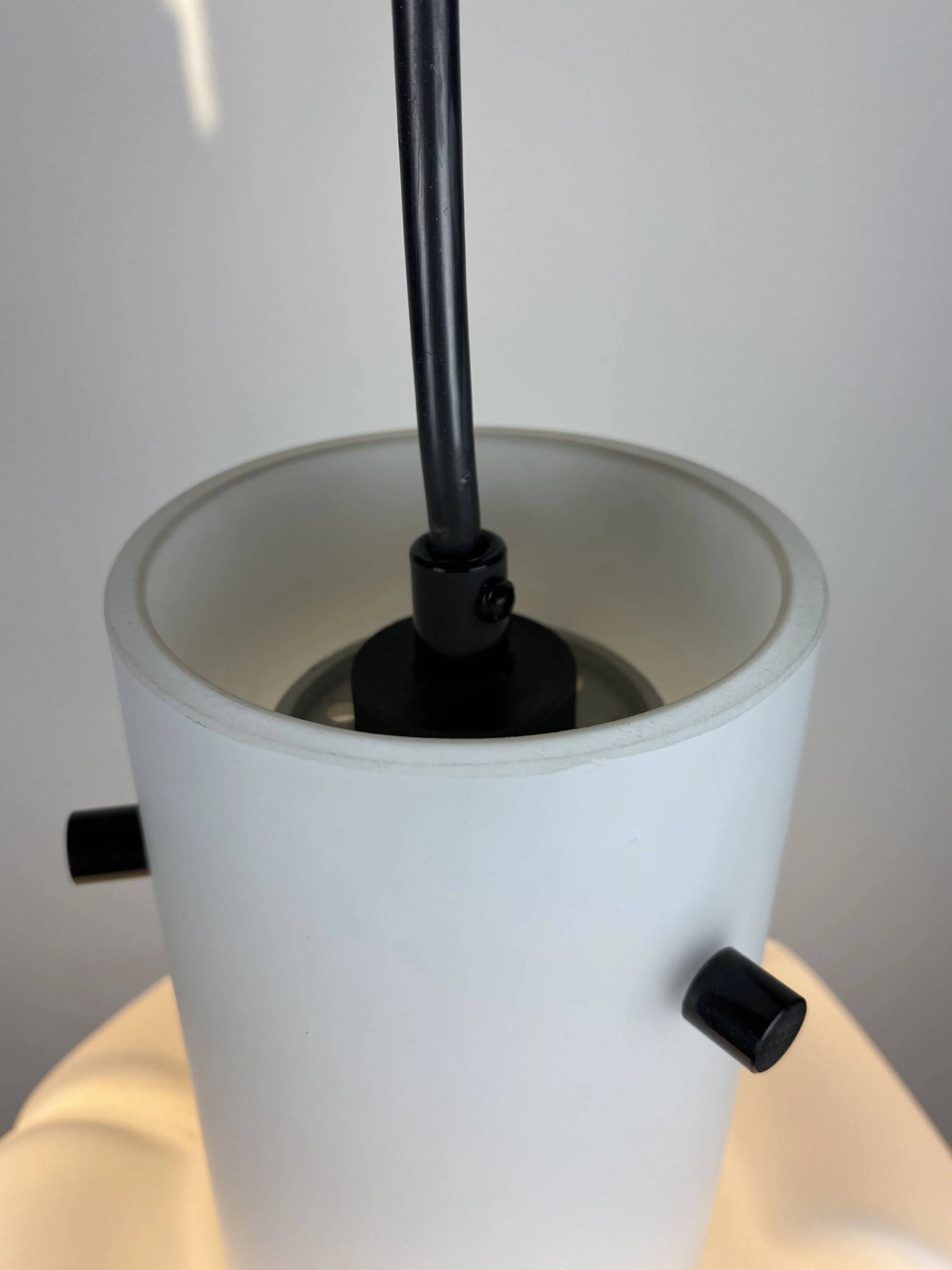 Frosted glass pendant in the shape of a white flower by Glashütte Limburg.