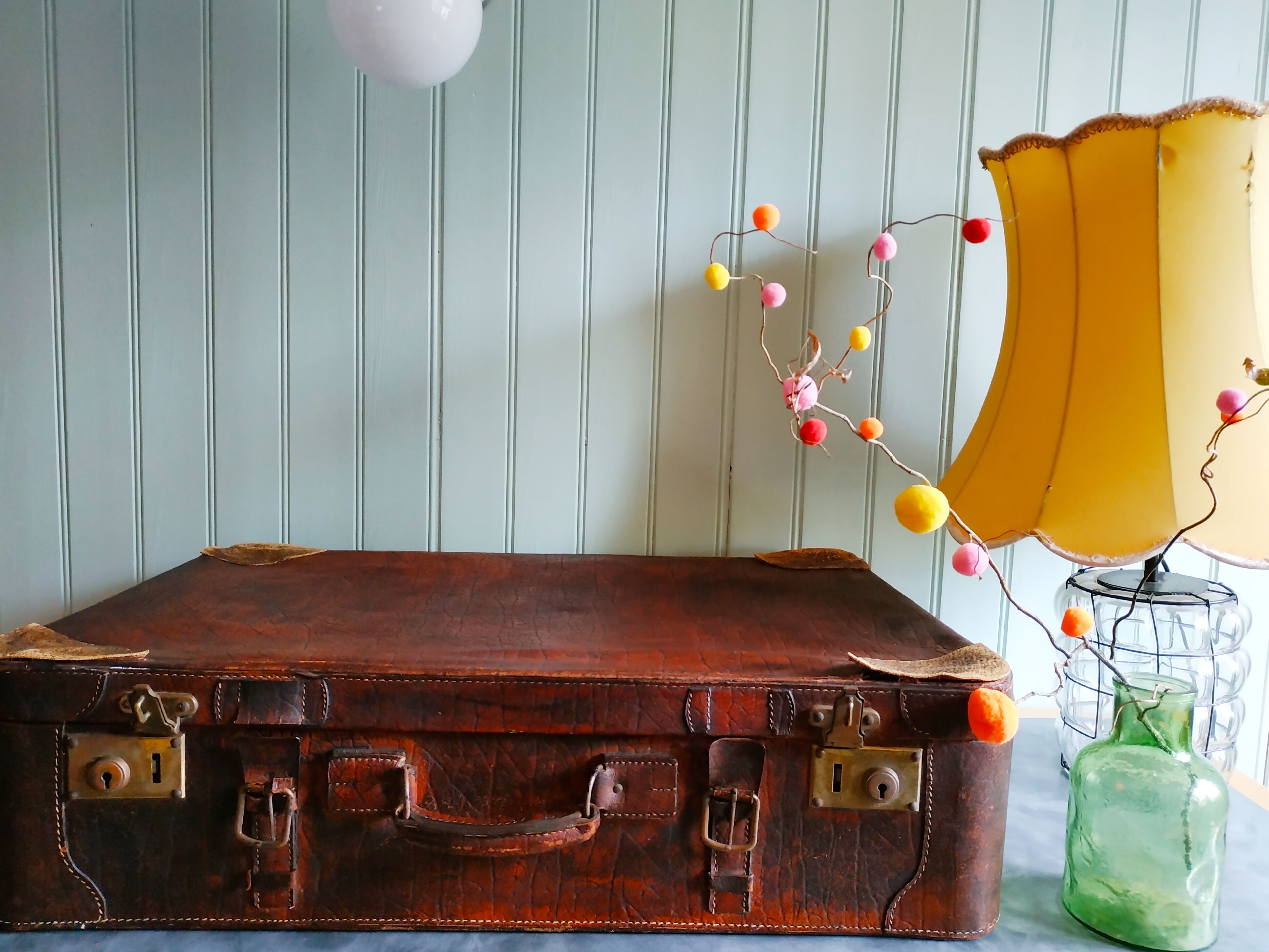 Old cardboard suitcase covered with patinated leather
