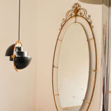 Oval mirror in art deco brass, Italy 1940s.