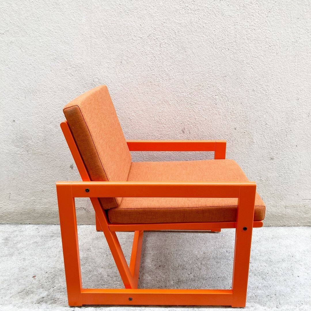 Orange designer armchair by Terence Conran