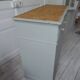 Antique sideboard enhanced in verdigris, wooden top.