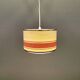 Hanging lamp with brass-coloured details, made of fabric with intact plastic bottom grille.