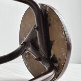 Dark brown metal stool, minimalist three-legged design