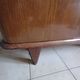 Vintage 1960s wooden wardrobe with a central mirror and tapered legs.
