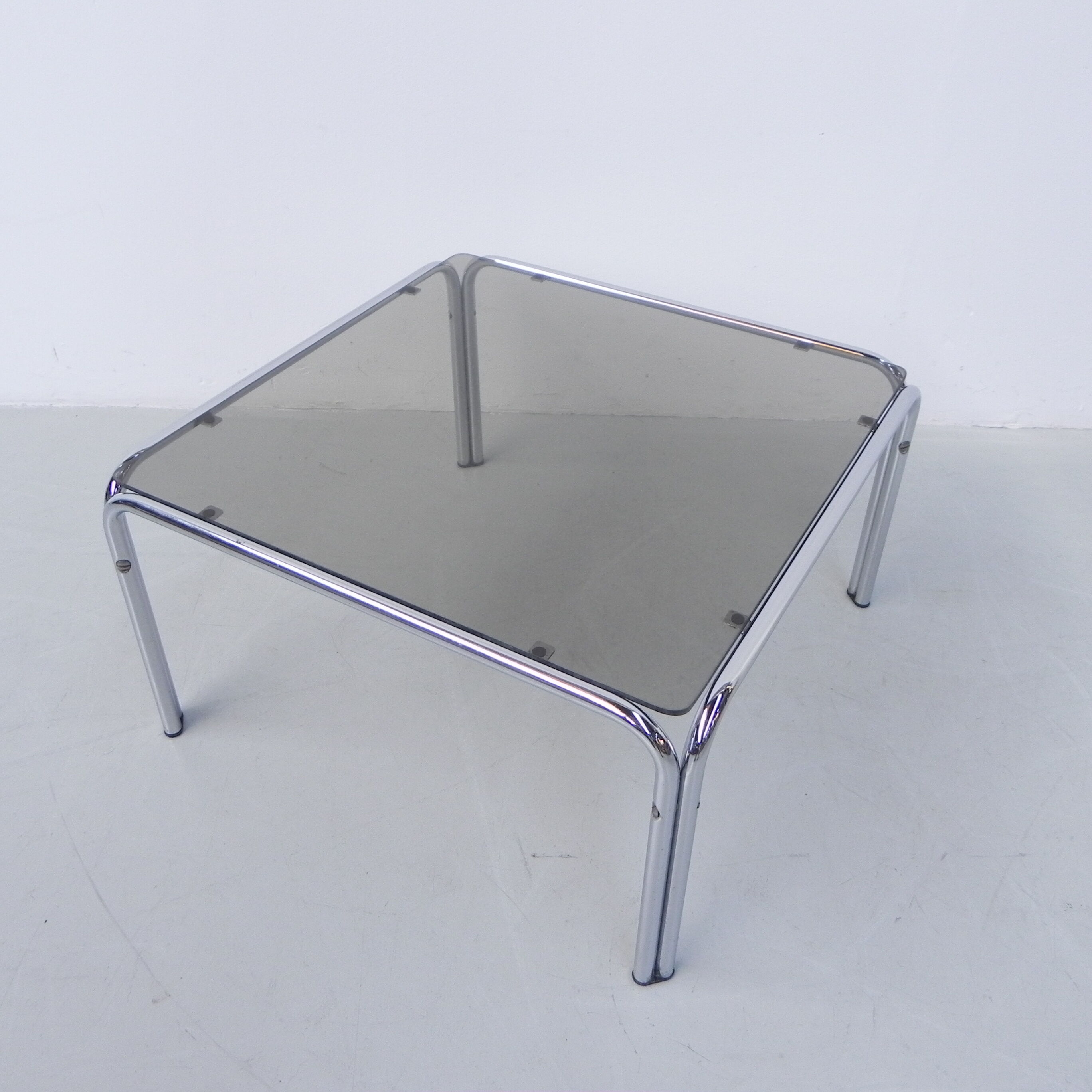 Coffee table with smoked glass top in chromed frame