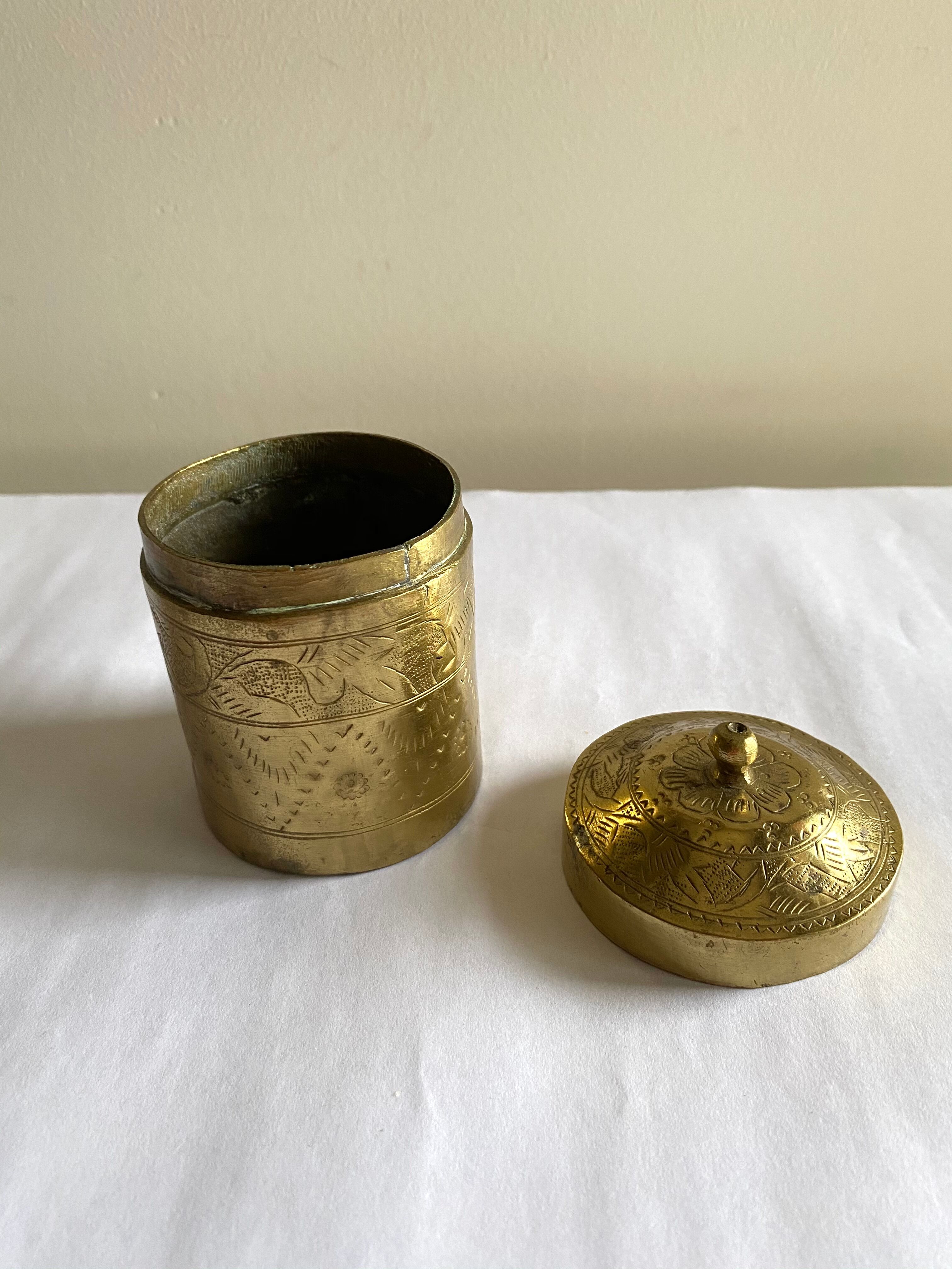 Old round box in chiseled brass