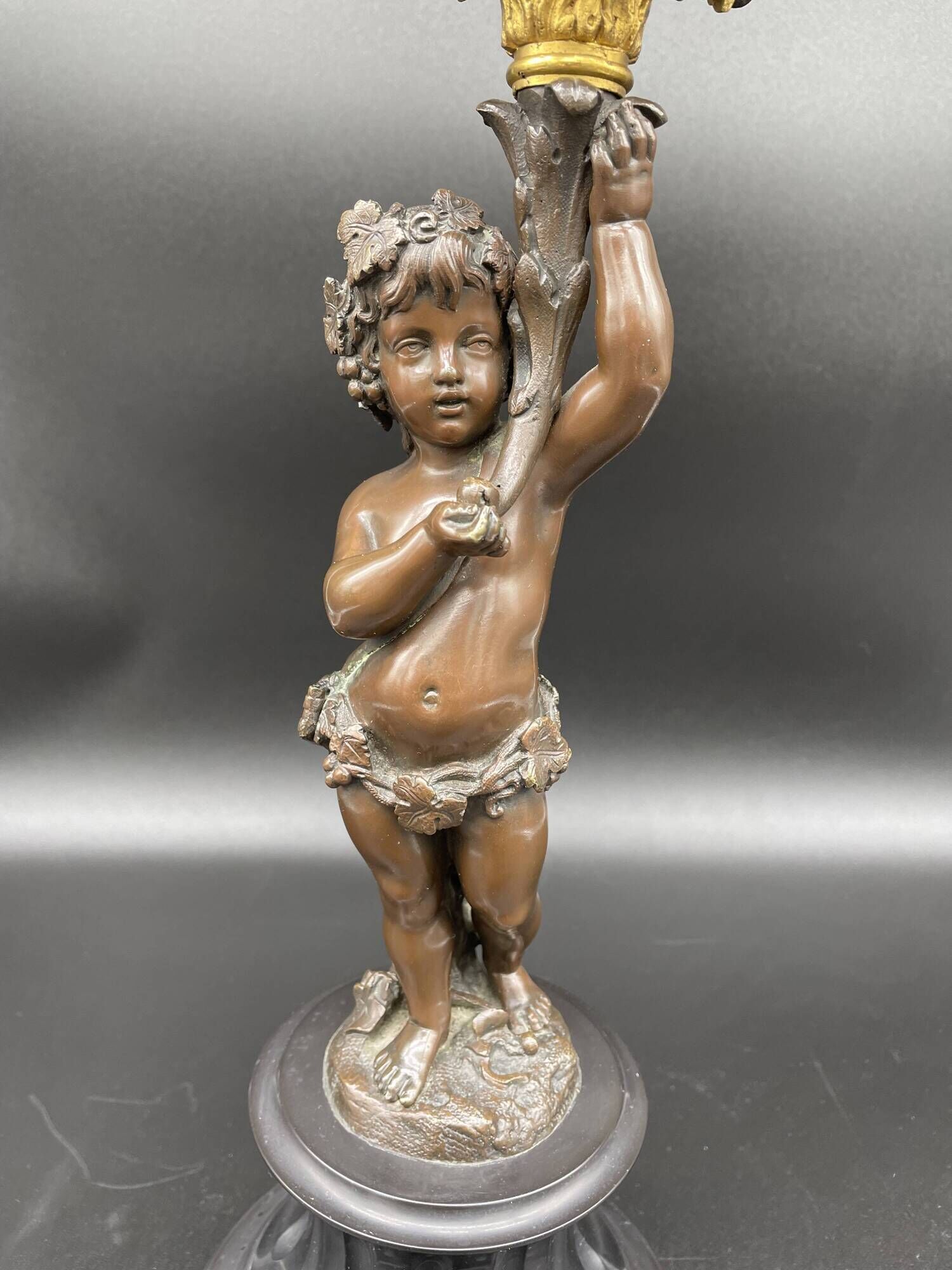 Candelabra with cherub in patinated bronze