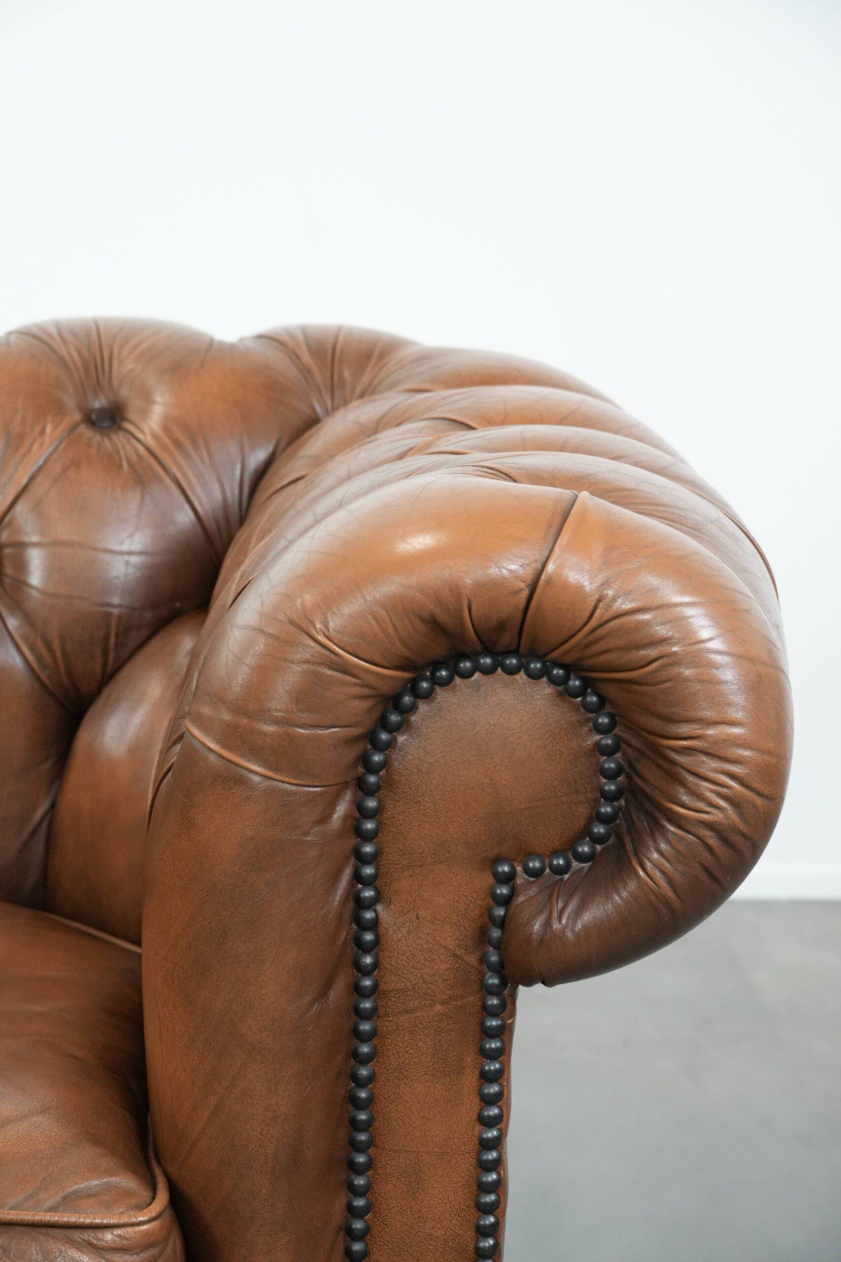 Brown cowhide leather chesterfield armchair  in English style on wheels