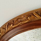 Antique oval mirror with beveled glass in wood and stucco, 19th century