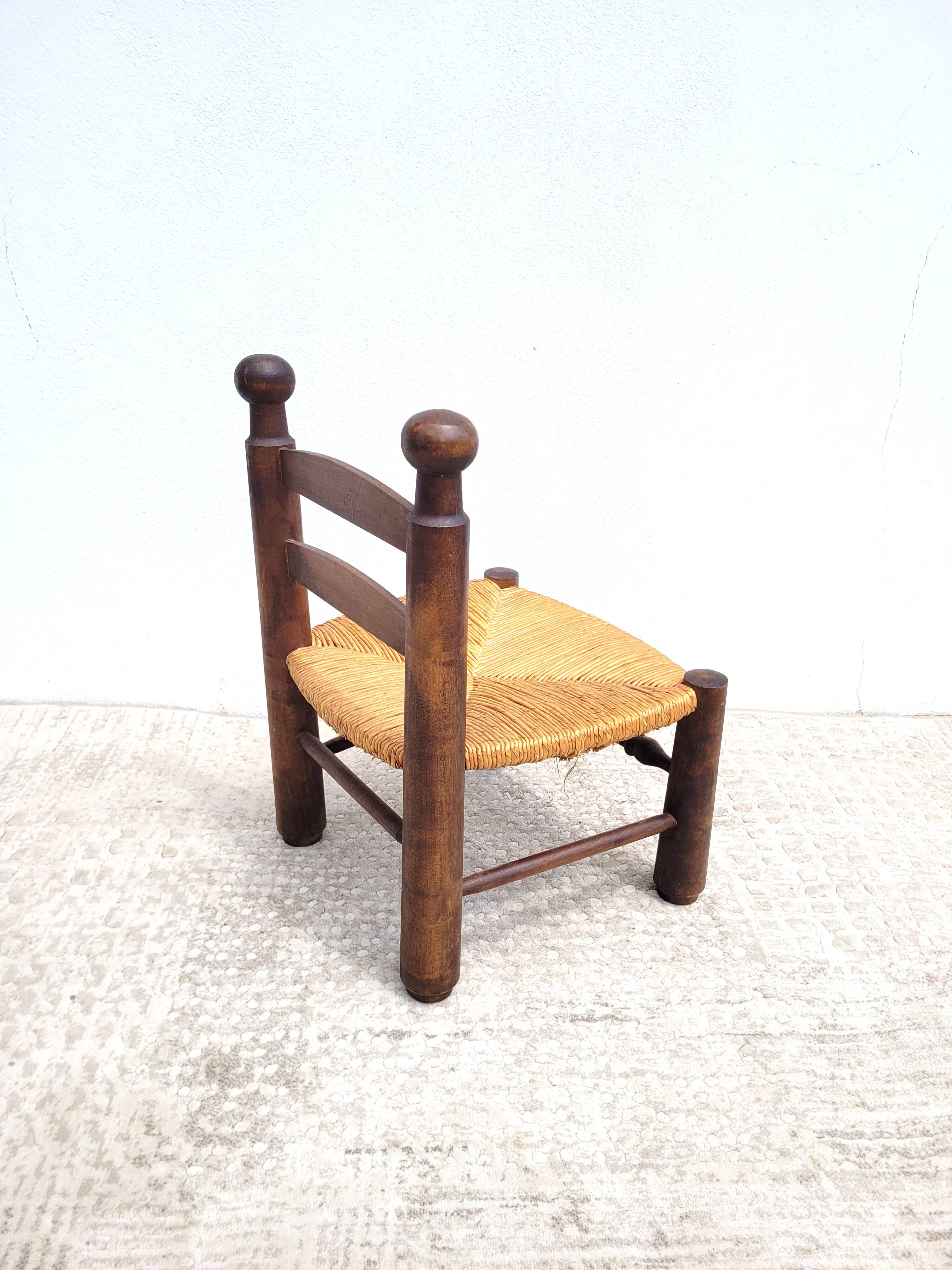 Low chair in turned wood and straw
