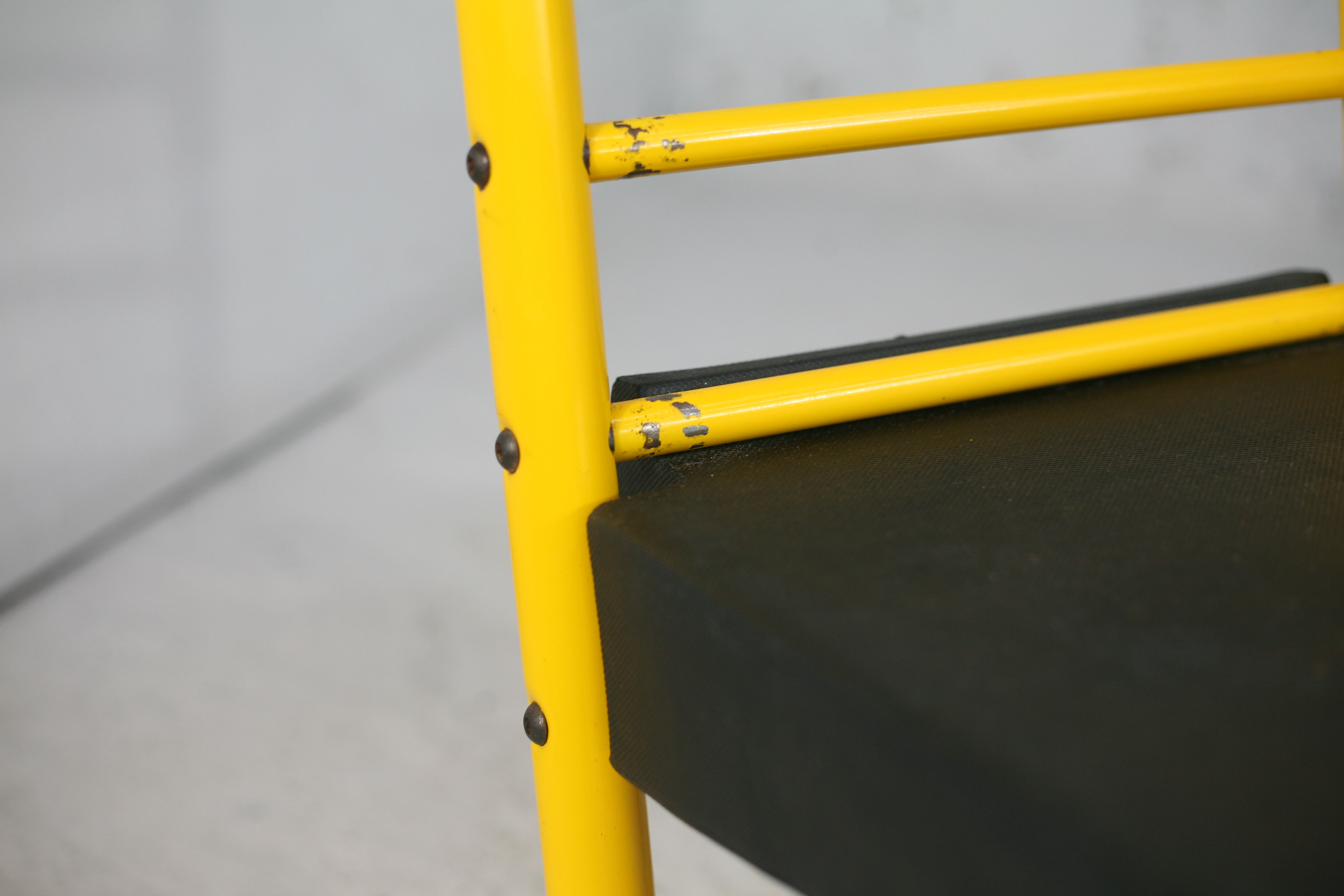 Adjustable seat chair. Circa 1980. Italy. Yellow lacquered steel.
